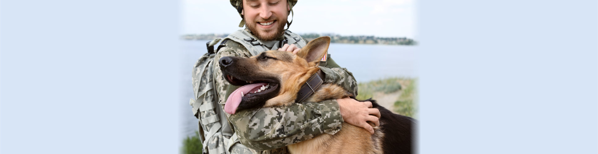 Man in military uniform with German shepherd dog outdoors