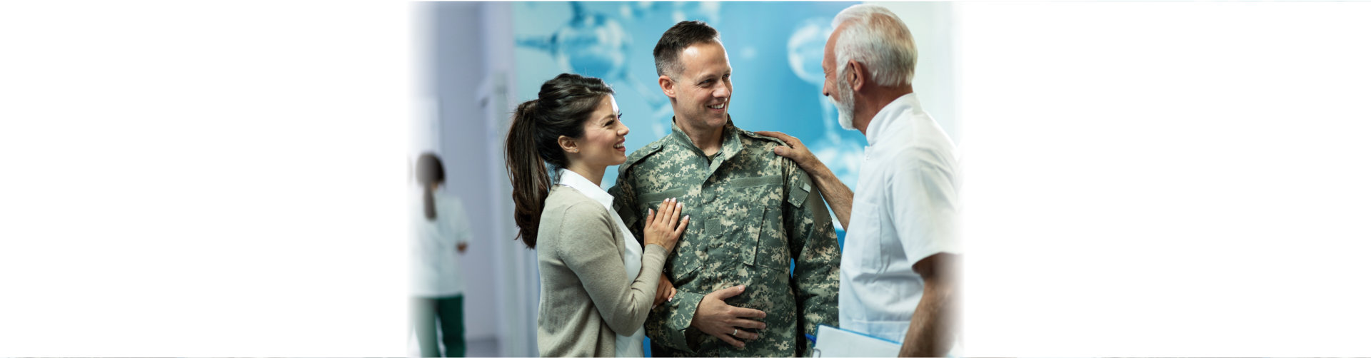 Happy military officer and his wife talking to a doctor